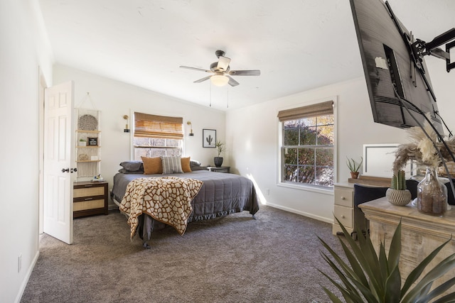 bedroom featuring multiple windows, vaulted ceiling, ceiling fan, and dark carpet