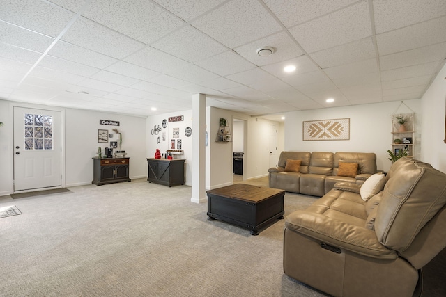 carpeted living room with a paneled ceiling