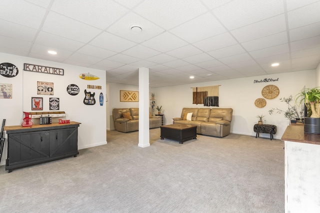 living room featuring a paneled ceiling and carpet