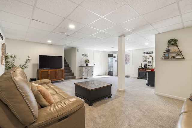 living room featuring a paneled ceiling and light colored carpet