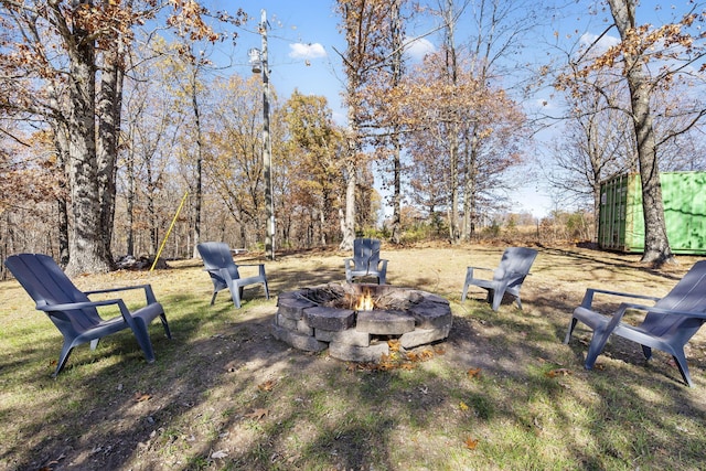 view of yard with a fire pit