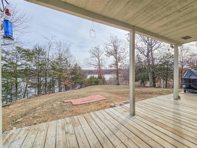 wooden deck featuring a water view