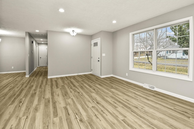 interior space with light hardwood / wood-style floors and a textured ceiling