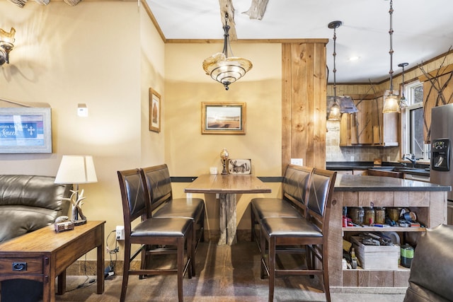 dining space with crown molding