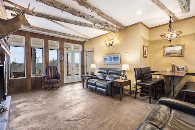 living room with beamed ceiling, french doors, and a healthy amount of sunlight