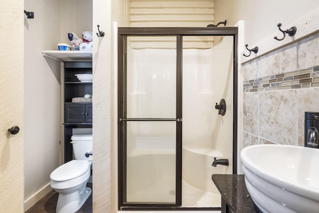 bathroom featuring sink, tile walls, an enclosed shower, and toilet