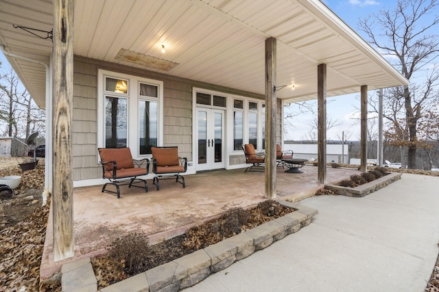 view of patio / terrace featuring a water view and french doors