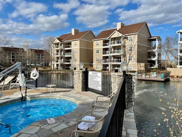 view of swimming pool with a water view