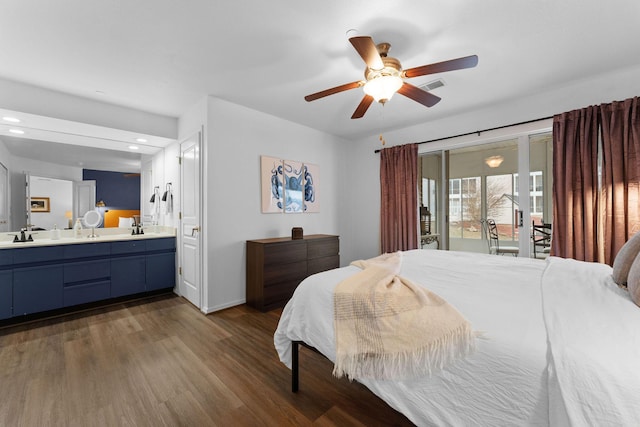 bedroom featuring sink, ceiling fan, access to exterior, ensuite bathroom, and dark hardwood / wood-style flooring