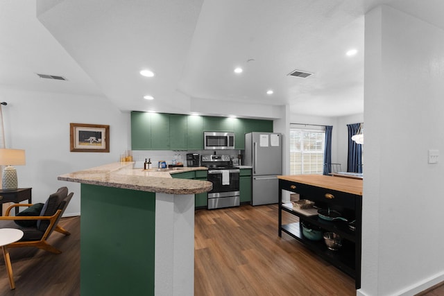 kitchen featuring dark wood-type flooring, stainless steel appliances, kitchen peninsula, and green cabinetry