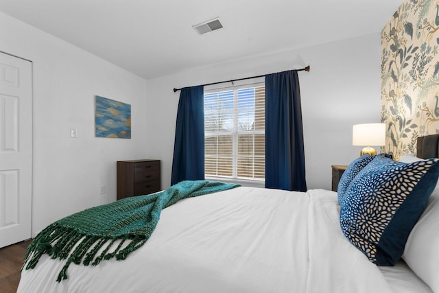 bedroom with dark hardwood / wood-style floors