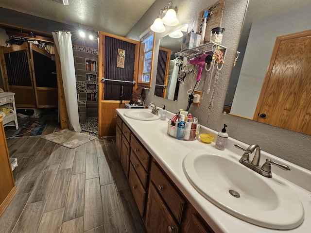 bathroom featuring vanity and a textured ceiling