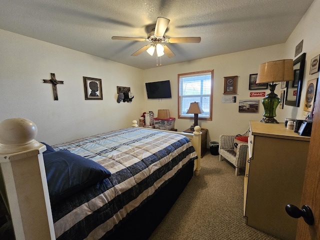 carpeted bedroom with ceiling fan and a textured ceiling