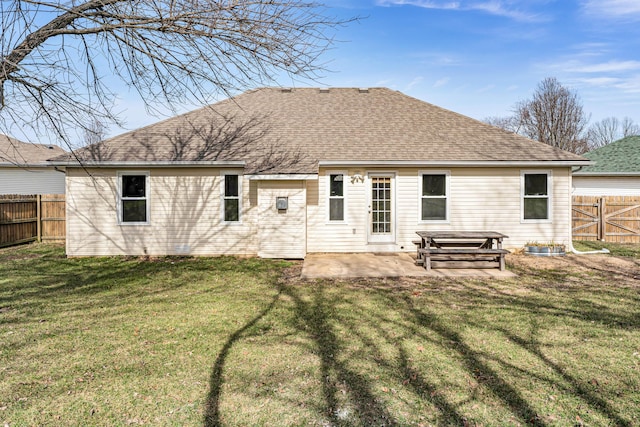 rear view of property featuring a patio and a lawn