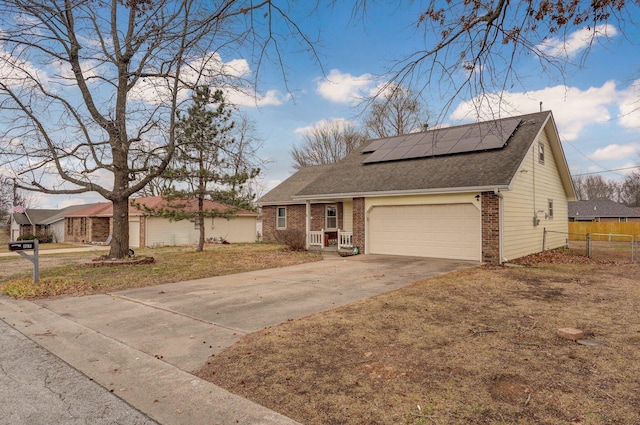 view of front facade with a garage, a front lawn, and solar panels