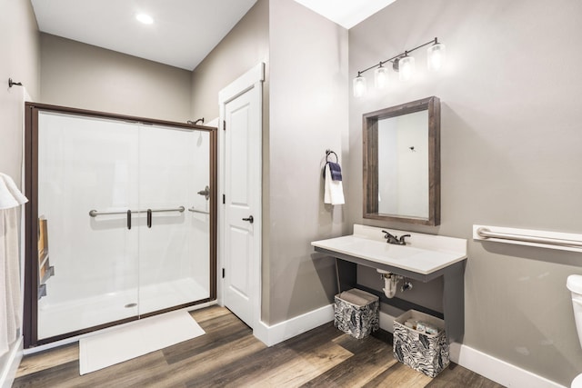 bathroom with hardwood / wood-style flooring and walk in shower