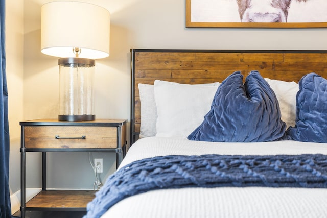 bedroom with dark hardwood / wood-style flooring