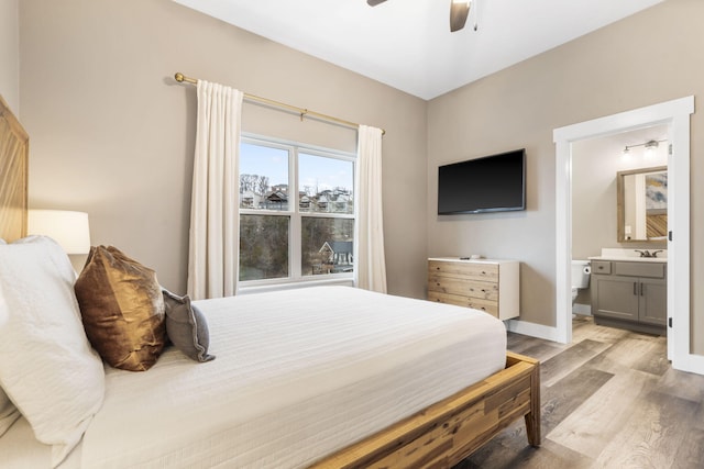 bedroom featuring ensuite bathroom, sink, ceiling fan, and light hardwood / wood-style flooring