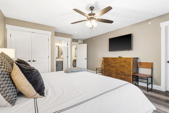 bedroom featuring ceiling fan, connected bathroom, hardwood / wood-style floors, and a closet