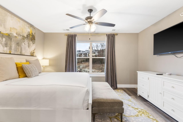 bedroom with dark wood-type flooring and ceiling fan