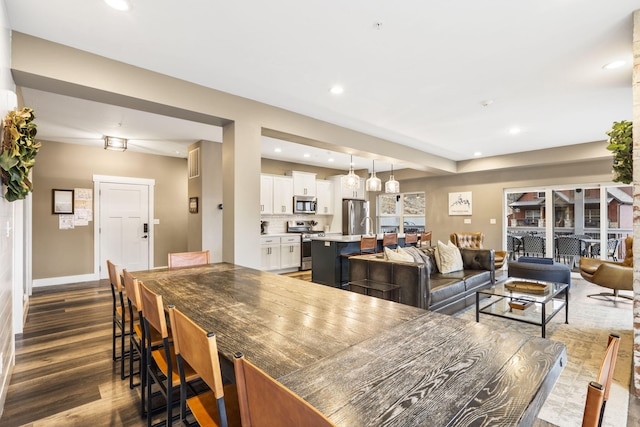 dining area featuring dark wood-type flooring