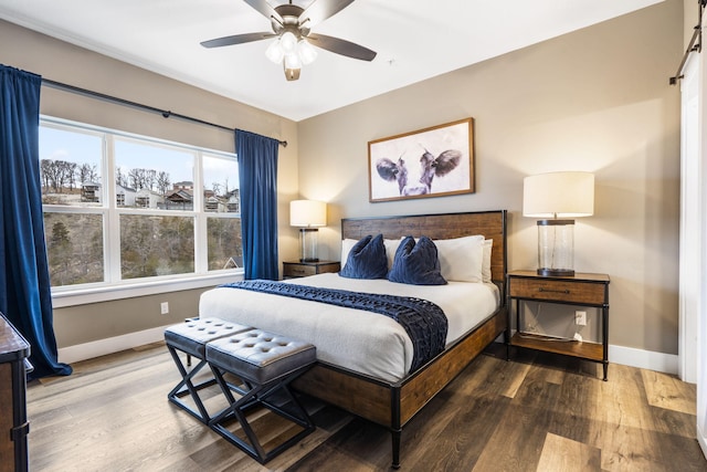 bedroom with dark hardwood / wood-style flooring and ceiling fan