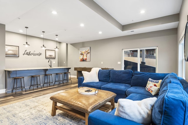 living room with wood-type flooring and indoor wet bar