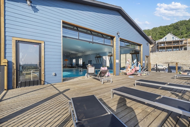 wooden terrace with a community pool