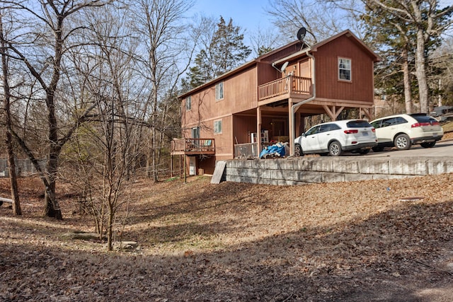 back of house with a wooden deck