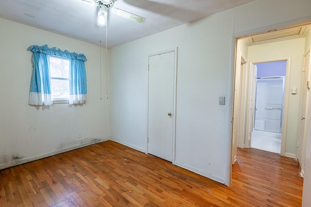 unfurnished bedroom with hardwood / wood-style floors and a closet