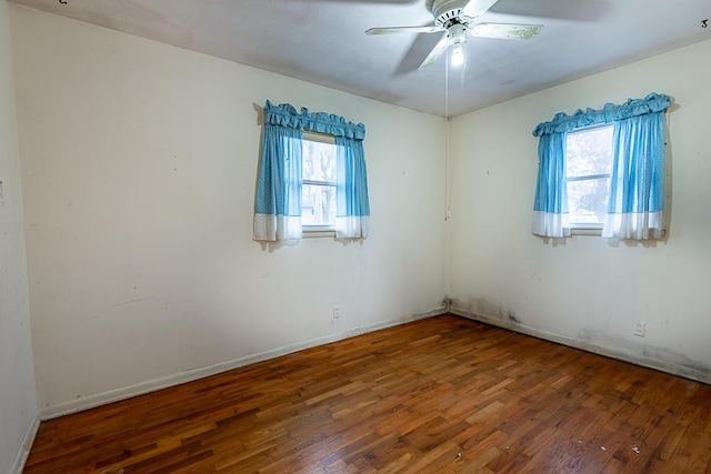 spare room with ceiling fan and wood-type flooring