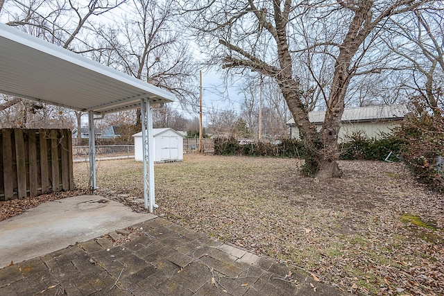 view of yard with a storage shed and a patio area