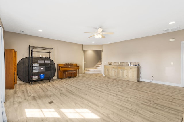 interior space with ceiling fan and light hardwood / wood-style flooring