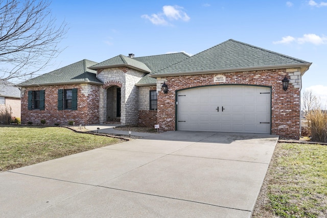 view of front of house with a garage and a front yard