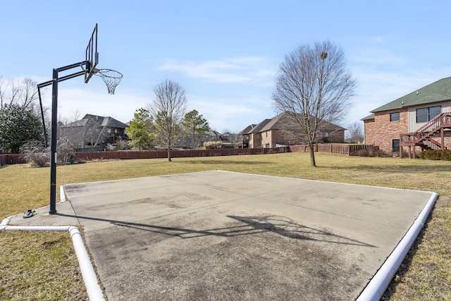 view of basketball court featuring a yard