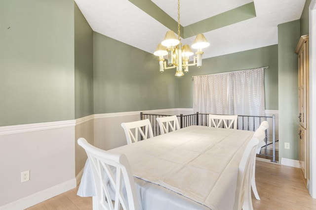 dining area featuring an inviting chandelier and light hardwood / wood-style flooring