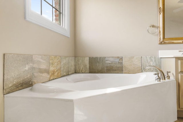 bathroom featuring a tub to relax in and vanity