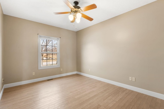 spare room with light hardwood / wood-style flooring and ceiling fan