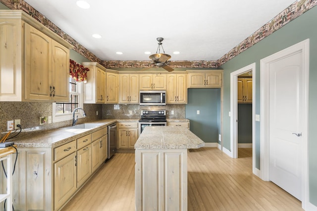 kitchen featuring stainless steel appliances, a center island, sink, and light brown cabinetry