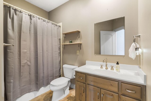 full bathroom with vanity, toilet, and shower / bath combo with shower curtain