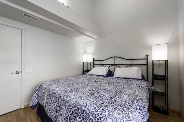 bedroom with dark hardwood / wood-style flooring