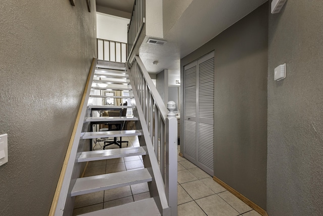 staircase featuring tile patterned floors