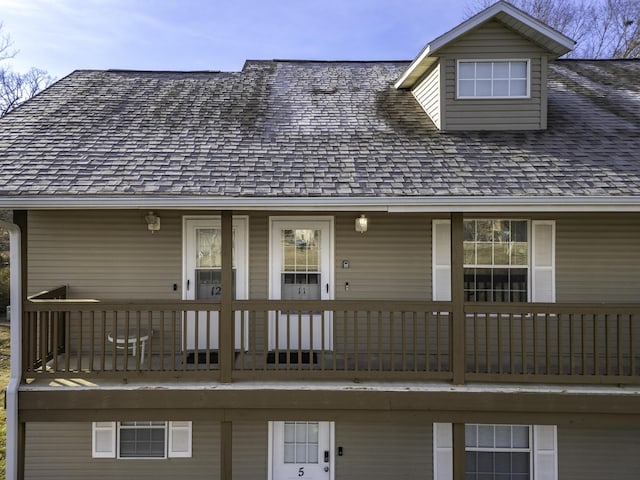 back of house featuring a balcony