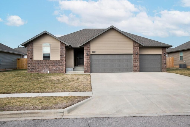 view of front of home featuring a garage, a front lawn, and central air condition unit