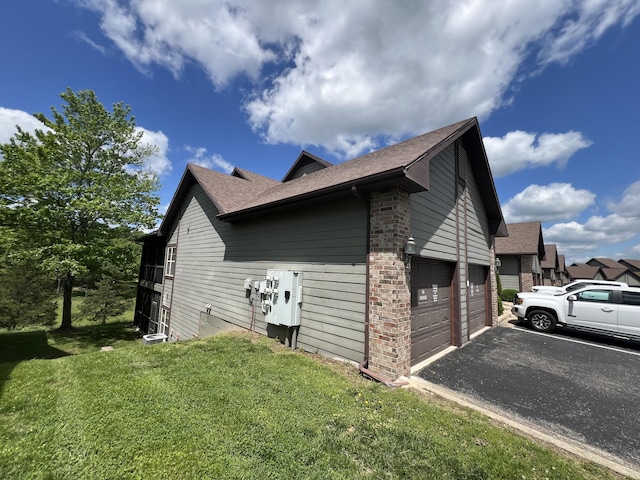 1241 Golf Dr Unit 1, Branson West, MO 65737 - view of property exterior with driveway, roof with shingles, a garage, brick siding, and a yard