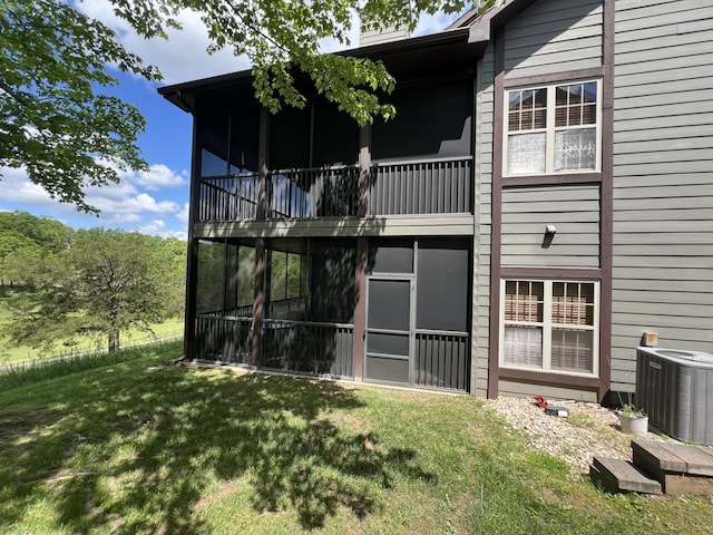 1241 Golf Dr Unit 1, Branson West, MO 65737 - rear view of house featuring a lawn, cooling unit, and a sunroom