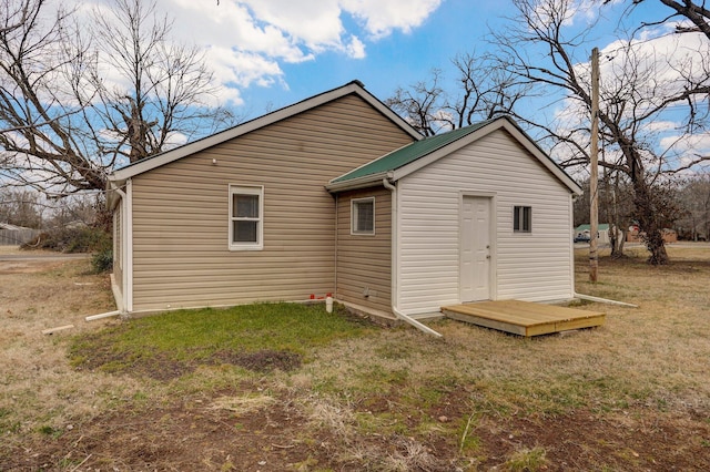 rear view of property with a lawn