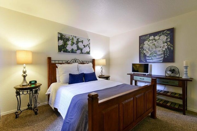 bedroom featuring dark carpet