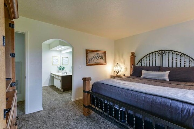 bedroom featuring light carpet and sink