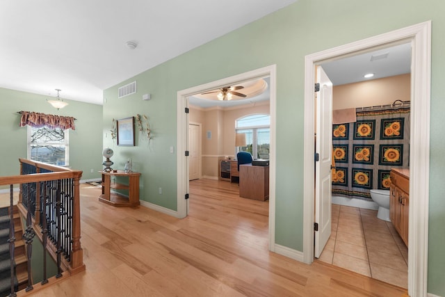 hallway with light hardwood / wood-style floors